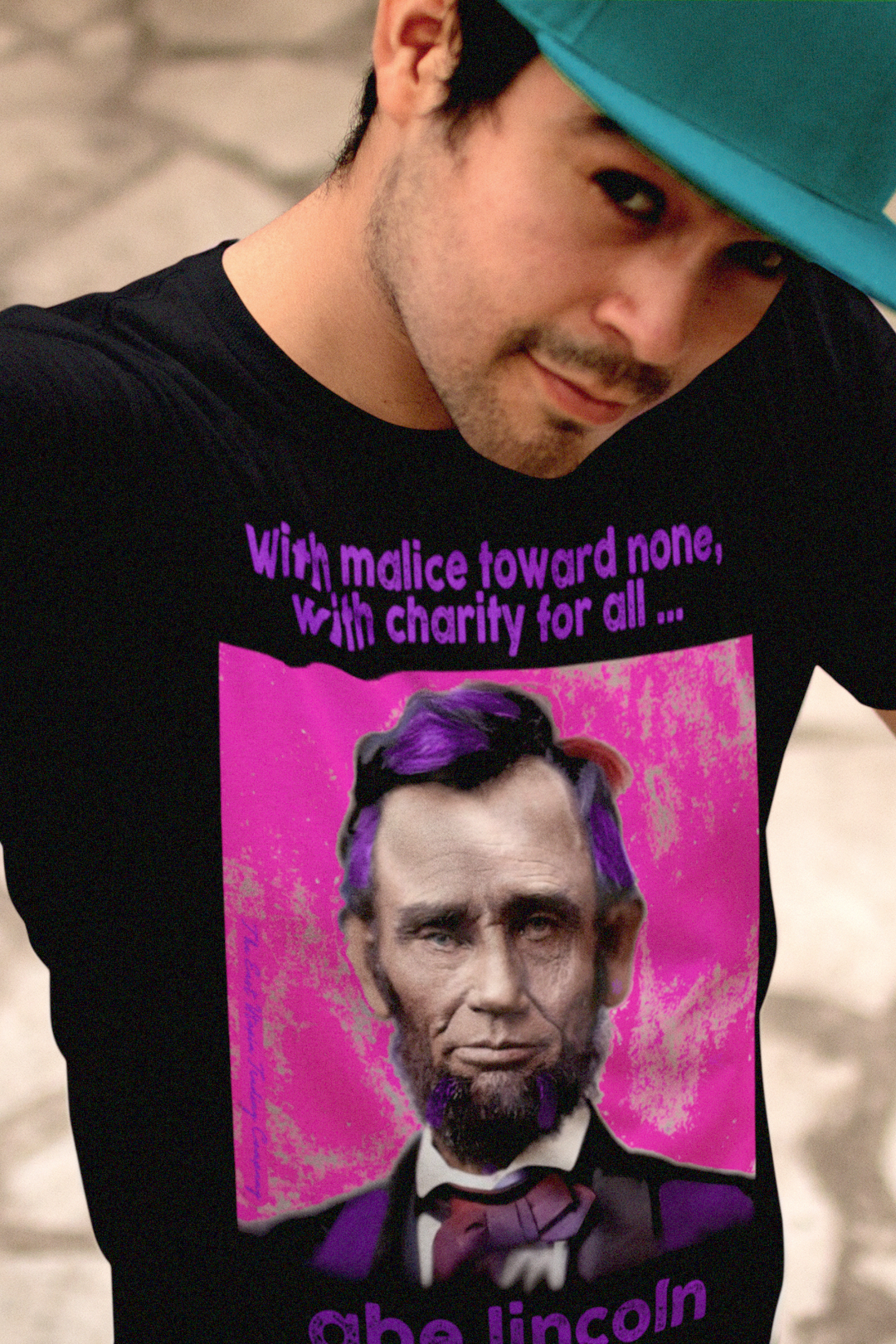 Young Latino man wearing a Basic Black T-Shirt with American Punk Abraham Lincoln — “With malice toward none, with charity for all.” From his Second Inaugural Address, delivered near the end of the Civil War, Lincoln’s words capture the nation’s moral high point amid its deepest wound. Great gift for American radicals and history buffs. Bella+Canvas 3501 Long Sleeve Jersey #EUTC
