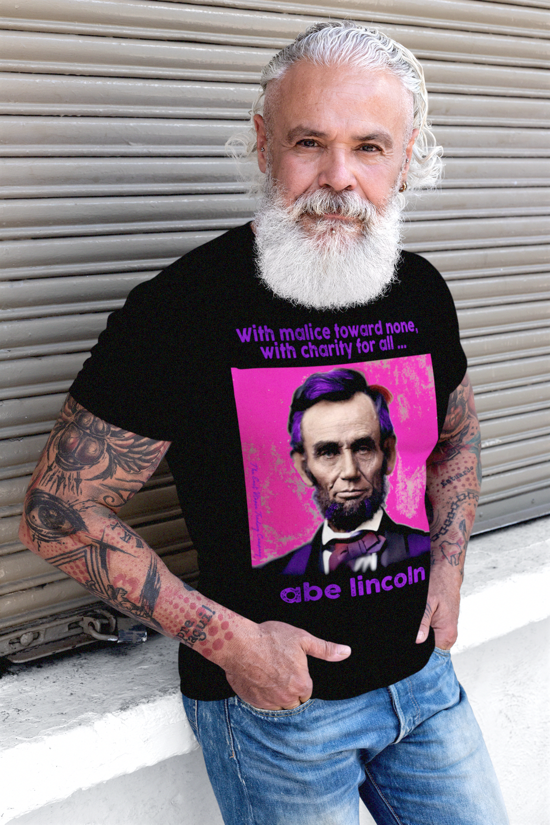Muscular older dude with tattoos and lumberjack beard wearing a Basic Black T-Shirt with American Punk Abraham Lincoln — “With malice toward none, with charity for all.” From his Second Inaugural Address, delivered near the end of the Civil War, Lincoln’s words capture the nation’s moral high point amid its deepest wound. Great gift for American radicals and history buffs. Bella+Canvas 3501 Long Sleeve Jersey #EUTC
