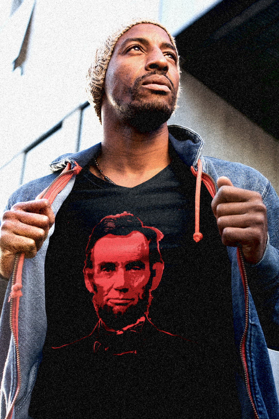 Black guy with wool cap  wearing a Basic Black T-Shirt depicting Abraham Lincoln: Blood of the Union. Lincoln wasn’t a saint dropped from the heavens—he was a messy, pragmatic politician shaped by the rough-and-tumble Free Soil movement and the hard edges of frontier republicanism. Perfect gift for the history buff in your life or any pragmatic radical. 

Bella+Canvas 3001  Basic T-Shirt #EUTC
