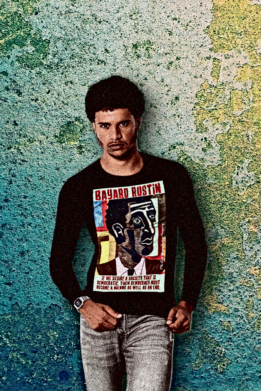 Black man with mutton chops and afro against a funky textured wall wearing a Black Long Sleeve Jersey of Bayard Rustin quote: “If we desire a society that is democratic, then democracy must become a means as well as an end.”

Bayard Rustin was the movement’s hidden architect—the strategist behind the March on Washington, the quiet genius who made nonviolence not just a philosophy but a logistics plan. 

Perfect gift for the civil rights activist in your life. Cotton Bella+Canvas 3501 #EUTC 
