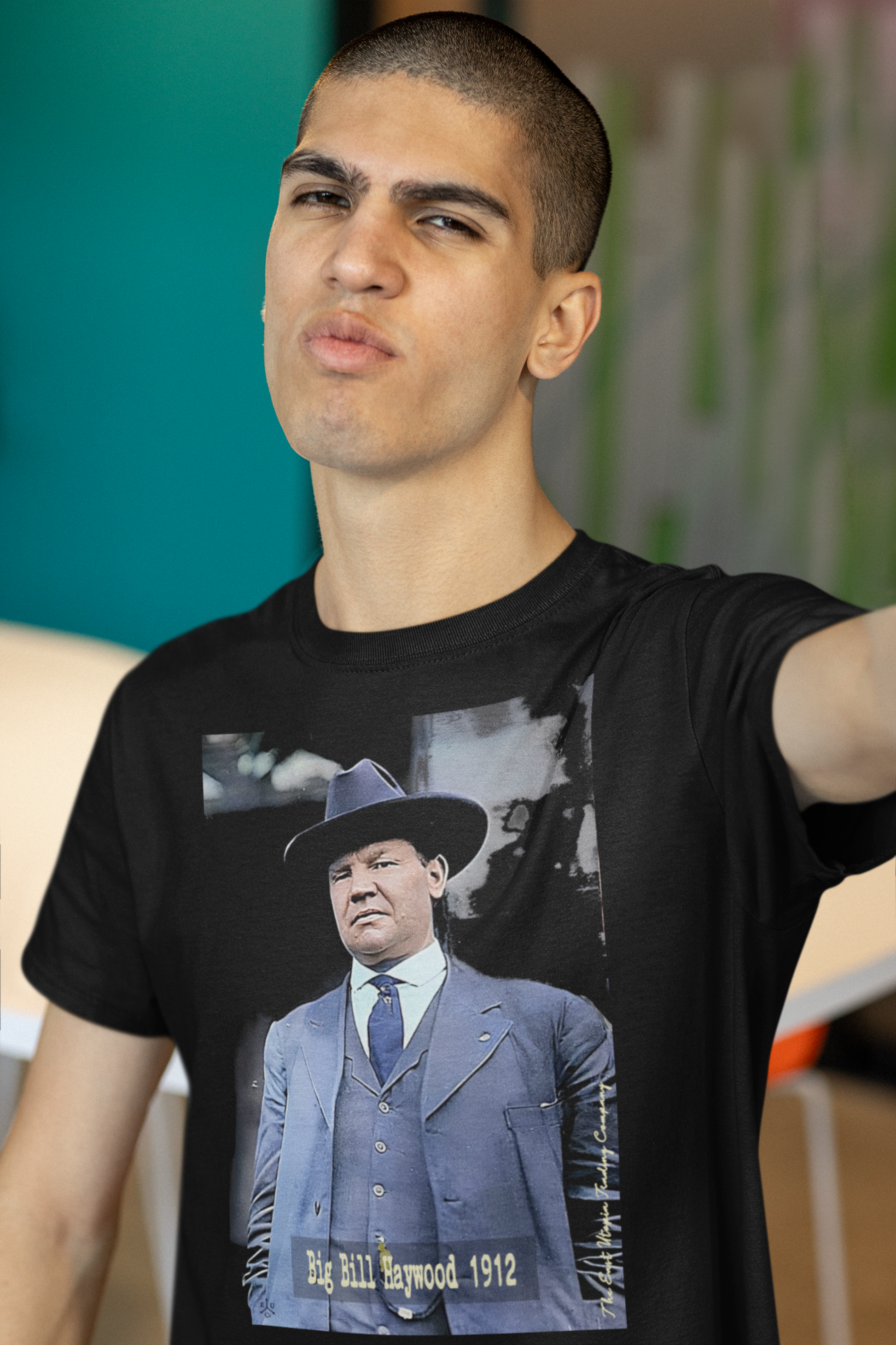 Basic Black T-Shirt depicting Big Bill Haywood, IWW organizer and strike leader who stood for solidarity across industries. Wobbly Bill Haywood—nicknamed “Big Bill”—was a one-eyed giant of labor radicalism, the muscle and roar of the IWW. He organized miners, lumberjacks, and migratory workers, the people capitalism chewed up and spat out, and he did it with a raw defiance that scared both bosses and the government. Perfect gift for the union organizer or anarcho-syndicalist radical in your life. 
