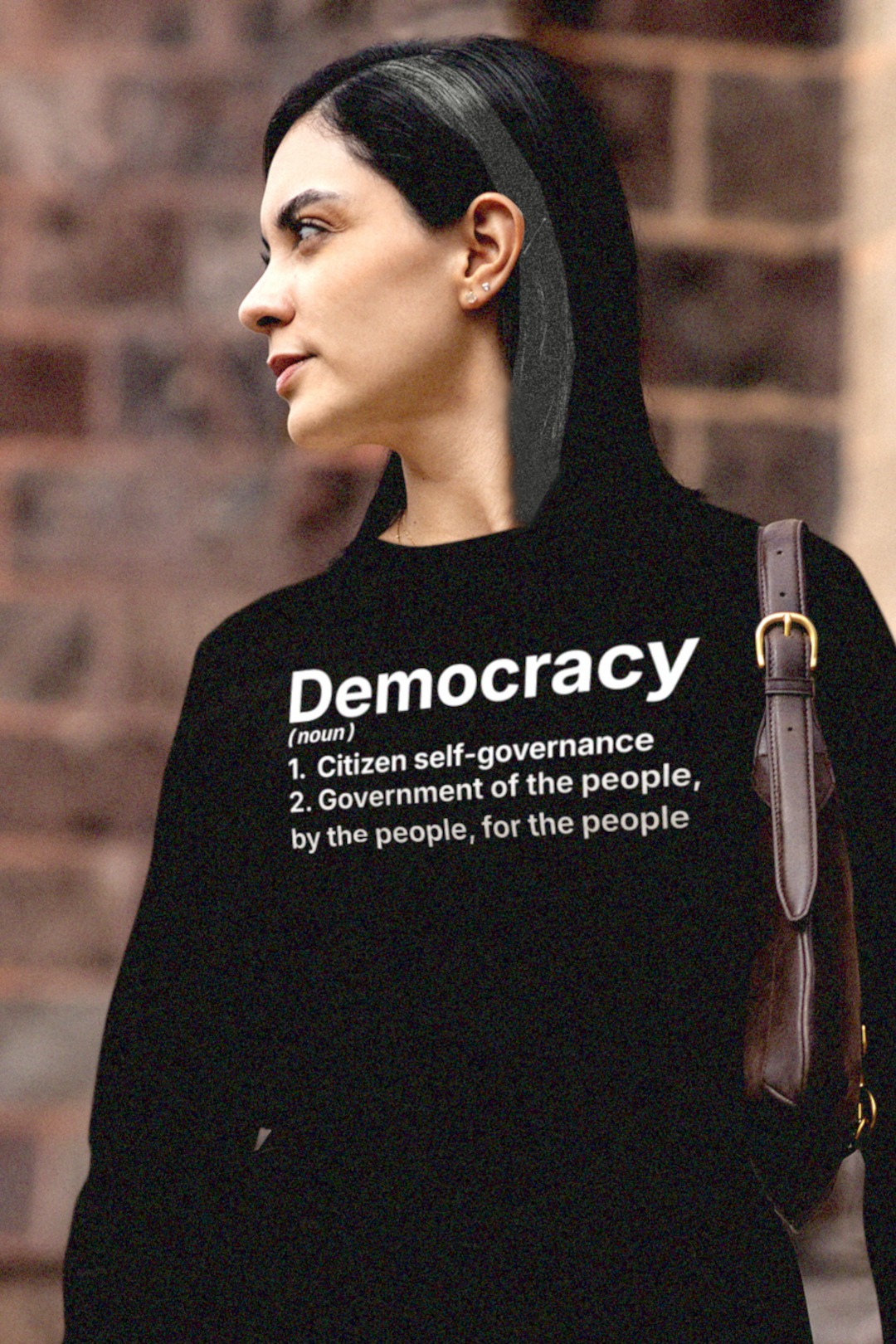 Gothesque law student woman wearing a black long sleeve jersey with 'Democracy' text standing on campus.


