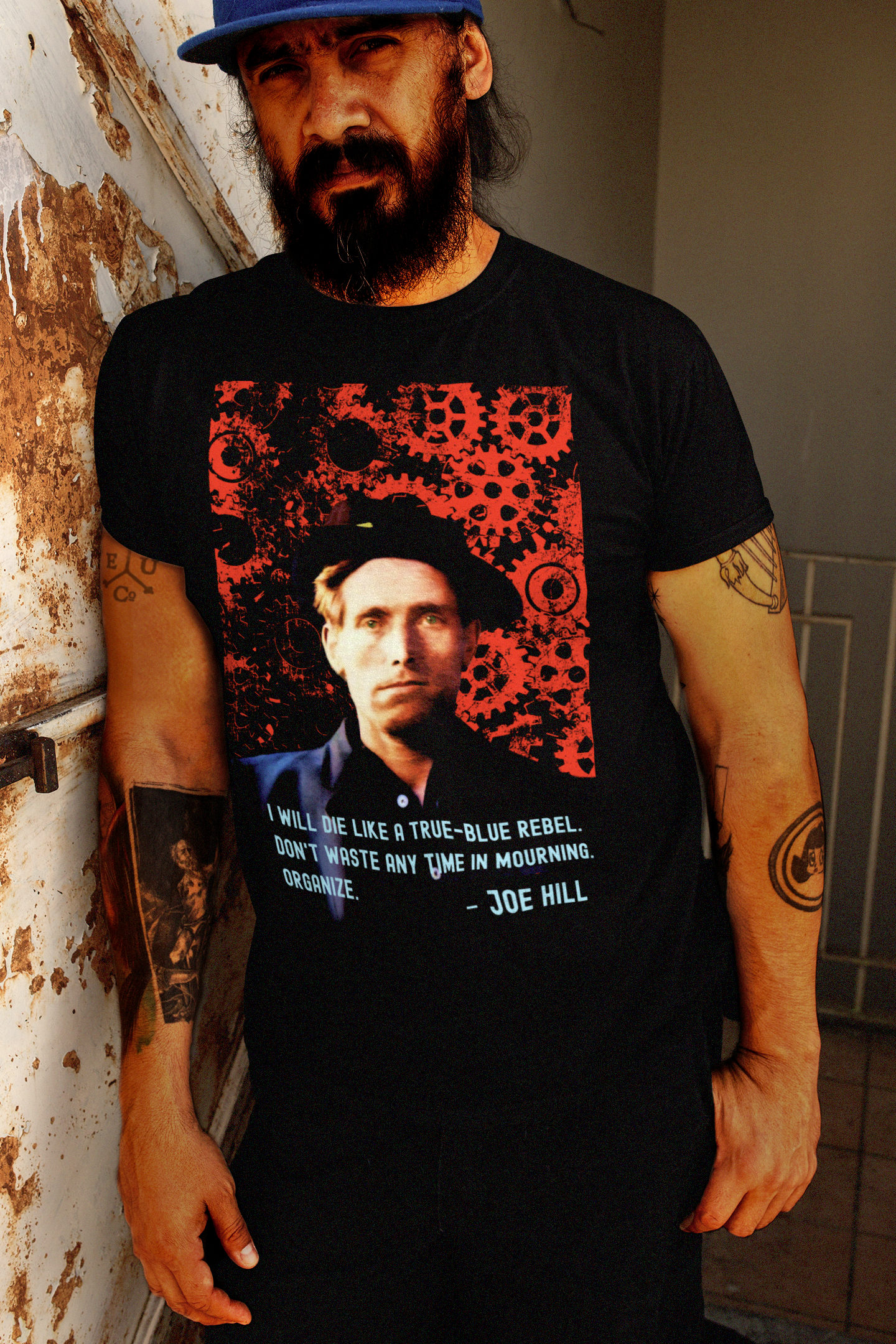 Tough bearded, tattooed Latino man wearing a Basic Black T-Shirt: Joe Hill, Wobbly IWW songwriter and labor martyr whose protest songs live on in union halls everywhere. “I will die like a true-blue rebel. Don't waste any time in mourning. Organize.”

Perfect gift for the labor organizer or anarcho-syndicalist in your life. Cotton Bella+Canvas 3001 #EUTC
