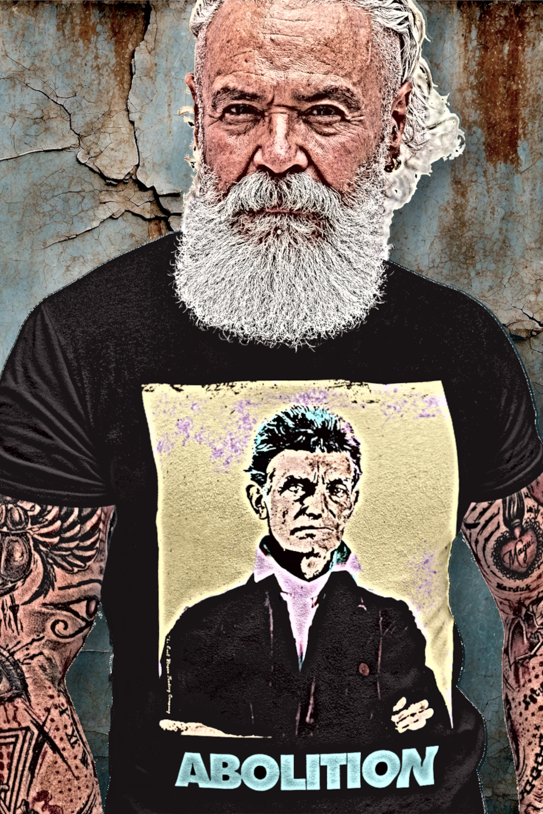 Bearded Tattooed Older Muscular Man in front of rusty wall wearing Basic Black T-Shirt: John Brown, militant abolitionist who fought slavery with uncompromising zeal and sacrifice. Cotton Bella+Canvas 3001 #EUTC