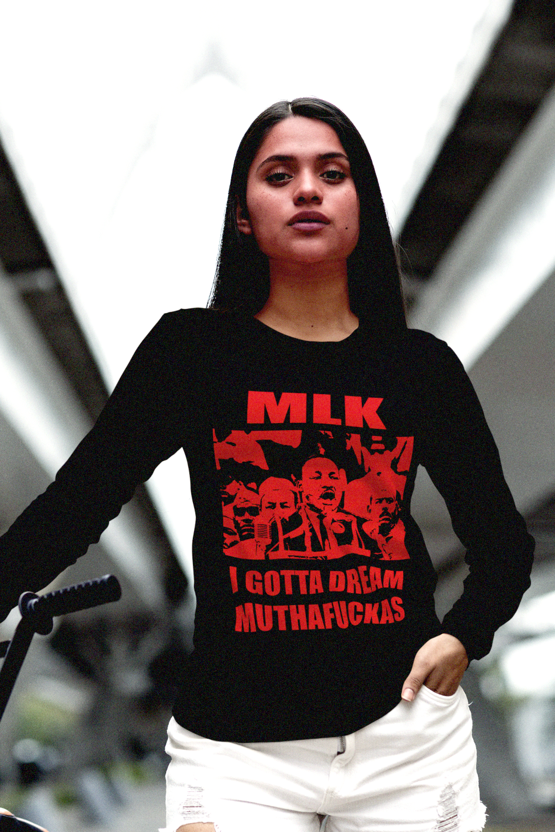 Proud Latina wearing red on black cotton long sleeve jersey of MLK: I GOTTA DREAM MUTHAFUCKAS an irreverent take on the famous I Have a Dream Speech. Great gift for Black Lives Matter activist.