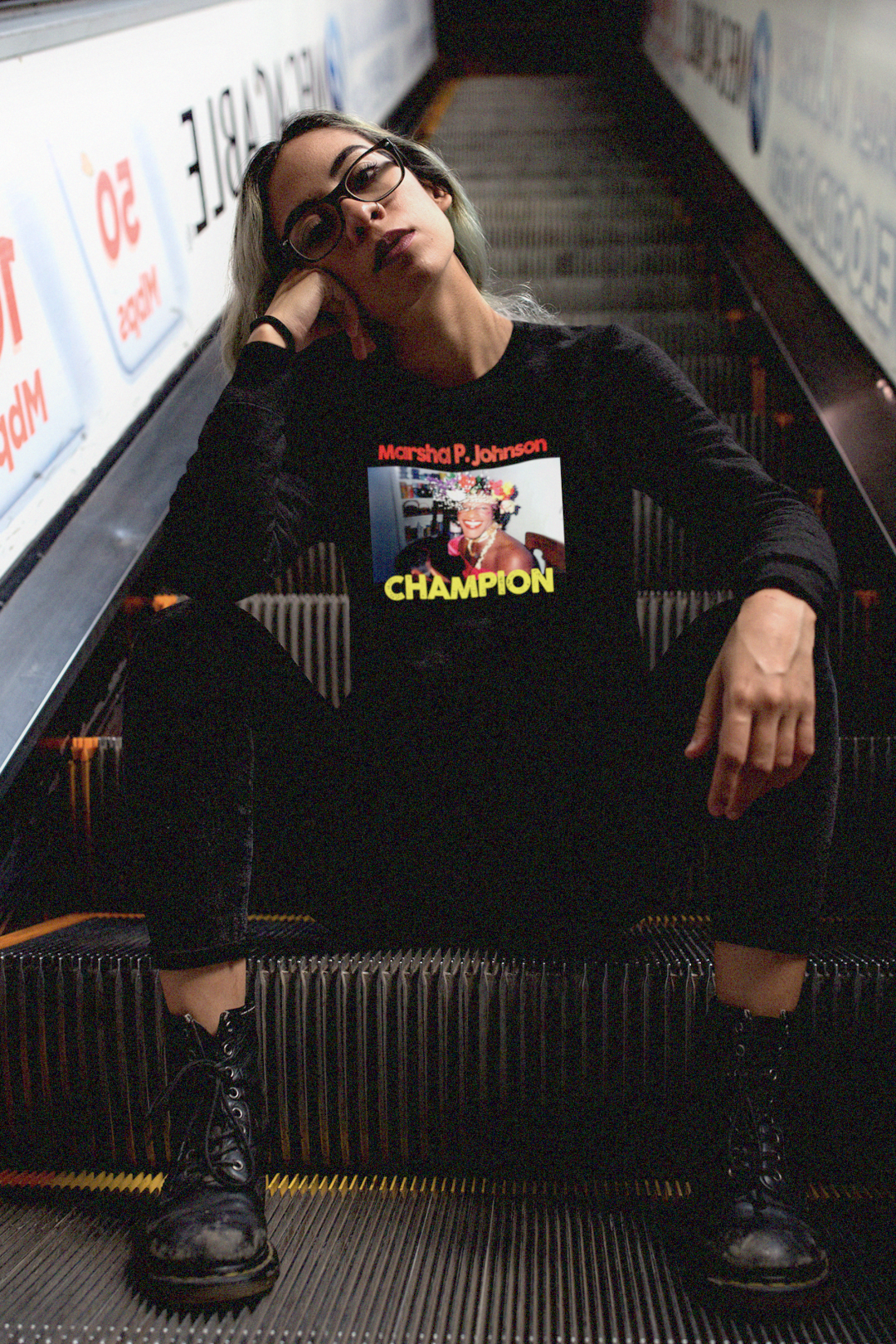 Queer green-haired woman in combat boots on a subway escalator wearing a  Long Sleeve Jersey depicting Marsha P. Johnson

Trans activist and Stonewall veteran Marsha P. Johnson (1945–1992) stood at the front lines of queer liberation. With joy, defiance, and radical love, she helped ignite the modern #LGBTQ+ rights movement.

Gift for the drag queen or trans activist in your life. Bella+Canvas 3501 | Long Sleeve Jersey  #Transrightarehumanrights #EUTC