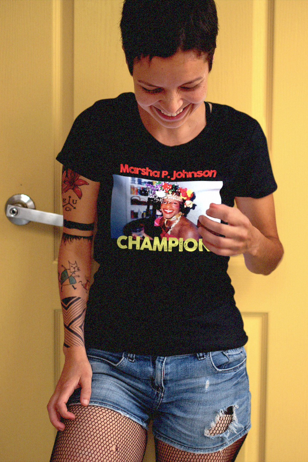 Fit lesbian with tattoos, fishnet stockings, and close cropped hair wearing a relaxed fit women's tee depicting Marsha P. Johnson.

 Trans activist and Stonewall veteran Marsha P. Johnson stood at the front lines of queer liberation. With joy, defiance, and radical love, she helped ignite the modern LGBTQ+ rights movement. 

Great gift for the drag queens, and the trans and LGBTQ activists in your life. 

Bella+Canvas Women’s Relaxed Tee 6400 #EUTC