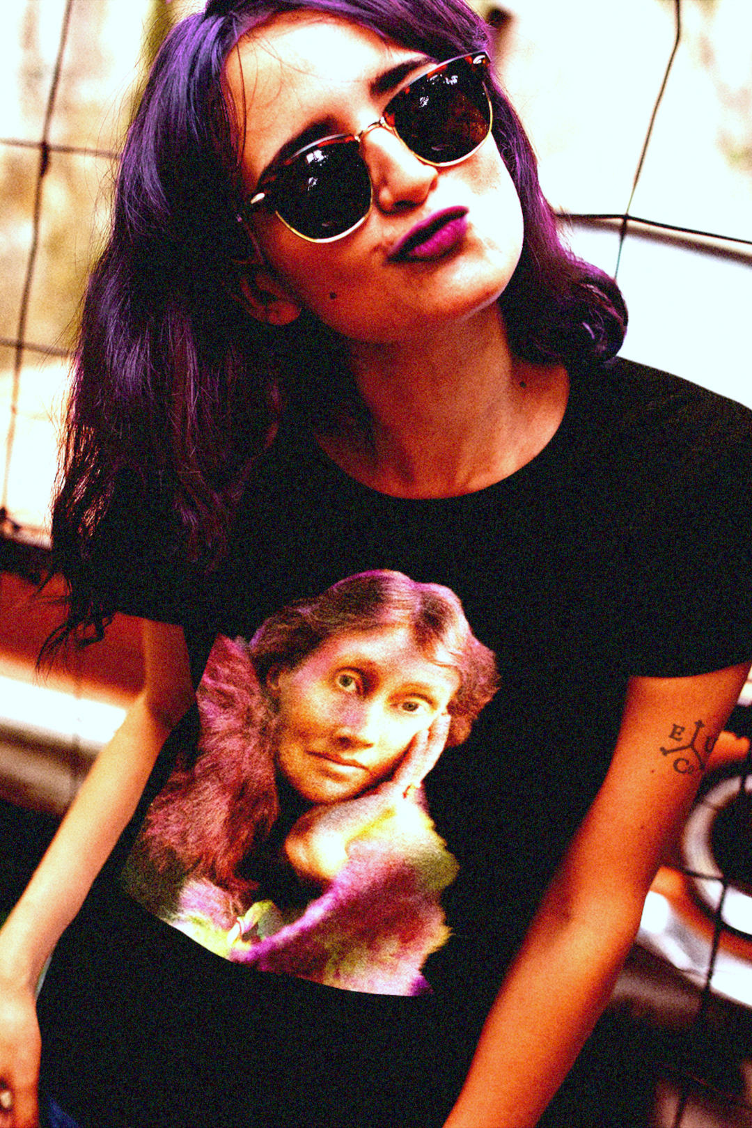 Groovy alt chick with purple hair, purple lips, purple vintage sunglasses in front of a vintage early sixties car sports a black cotton Virginia Woolf t-shirt in technicolor. 

Perfect gift for your book club friend or the English major in your life. Black cotton Bella+Canvas 3001. 