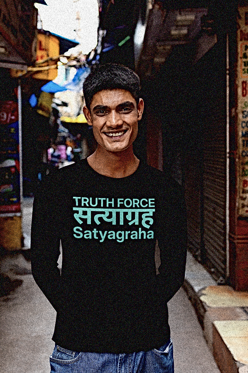 Tall Indian man in a bazaar alley wearing a Black Long Sleeve Jersey: Definition: SATYAGRAHA (noun) from the Sanskrit 1. Truth Force 2. A philosophy and practice of nonviolent resistance to injustice: holding firmly to truth. Holding firmly to truth, or truth force, is a particular form of nonviolent resistance. 

Perfect gift for the nonviolent protester in your life. Cotton Bella+Canvas 3501 #EUTC