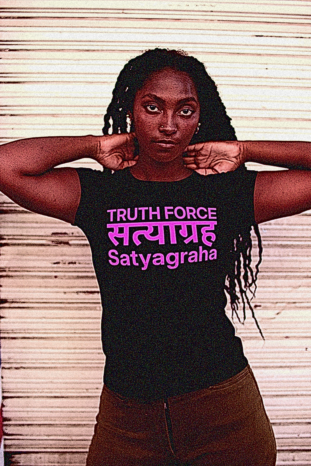 Bold Black Woman with long natting braids in an industrial setting wearing a Black Relaxed Fit Women's Tee: SATYAGRAHA सत्याग्रह: Truth Force -  Holding firmly to truth, or truth force, is a particular form of nonviolent resistance or civil resistance. Someone who practises satyagraha is a satyagrahi. The term satyagraha was coined and developed by Mahatma Gandhi and extended by MLK. Perfect gift for the nonviolent resister in your life. Cotton Bella +Canvas 6400 #EUTC