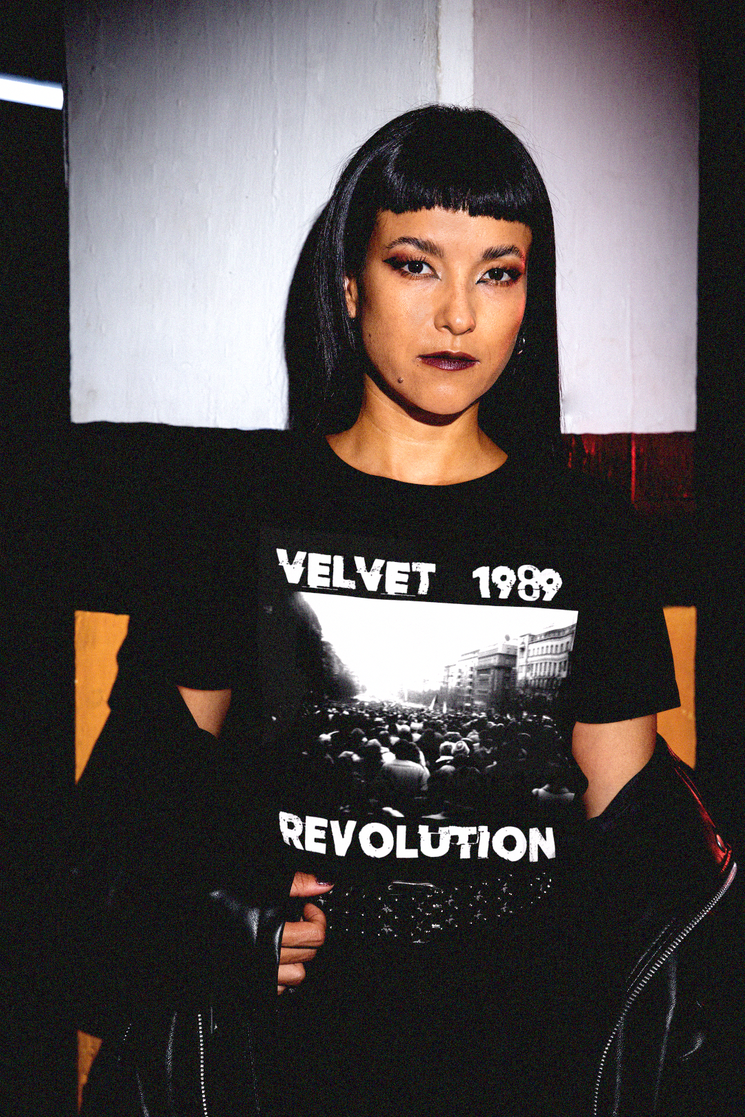 Goth, emo woman wearing a black t-shirt with 'Velvet 1989 Revolution' design. Perfect gift for the dissident protester in your life. 