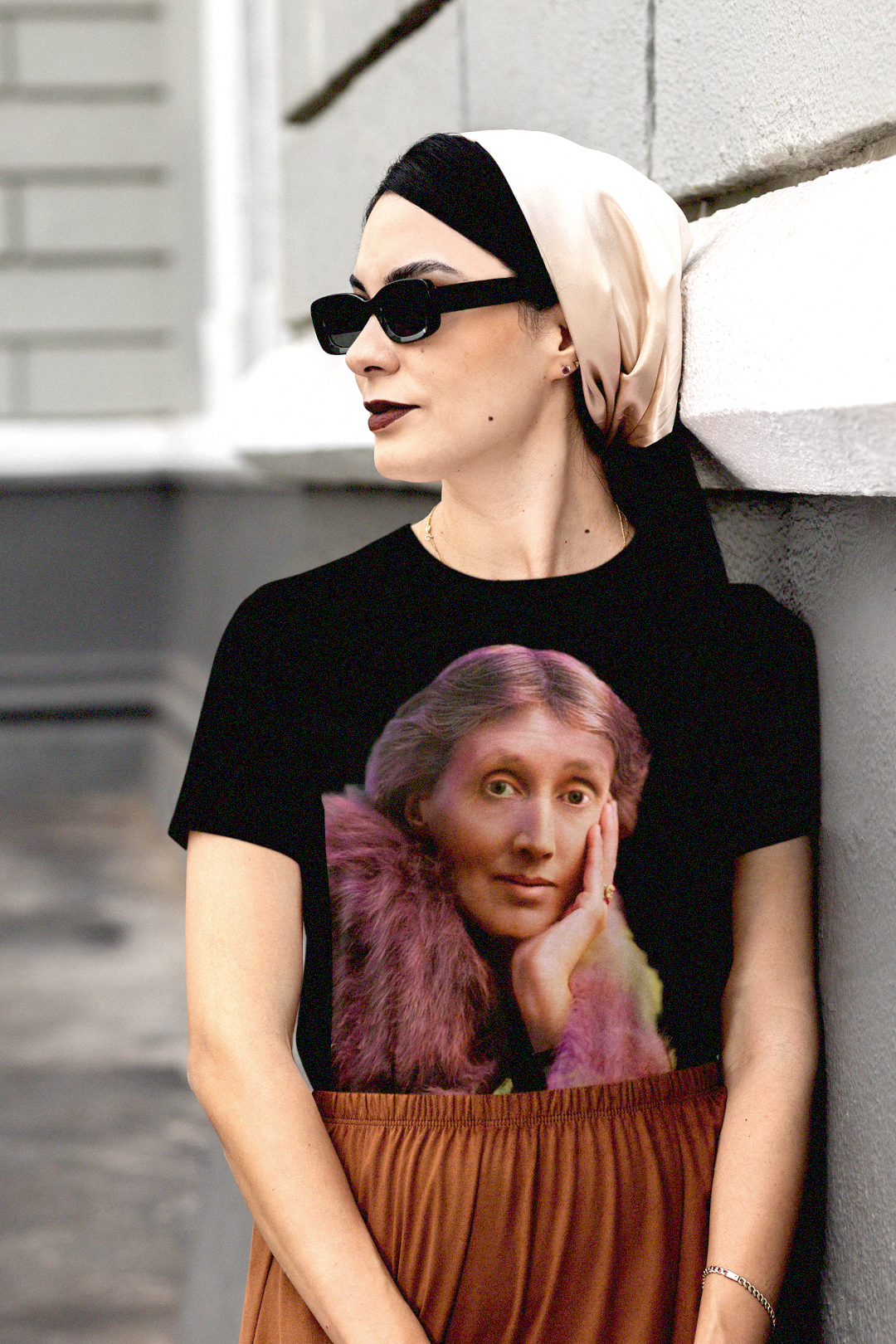 Chic woman wearing stylish shades and a head scarf with a basic black t-shirt of technicolor portrait of Virginia Woolf. She made literature new—stream-of-consciousness, fractured time, inner lives spilling across the page.

Perfect gift for your book club friend or the English major in your life. 
Bella+Canvas 3001 | Basic T-Shirt