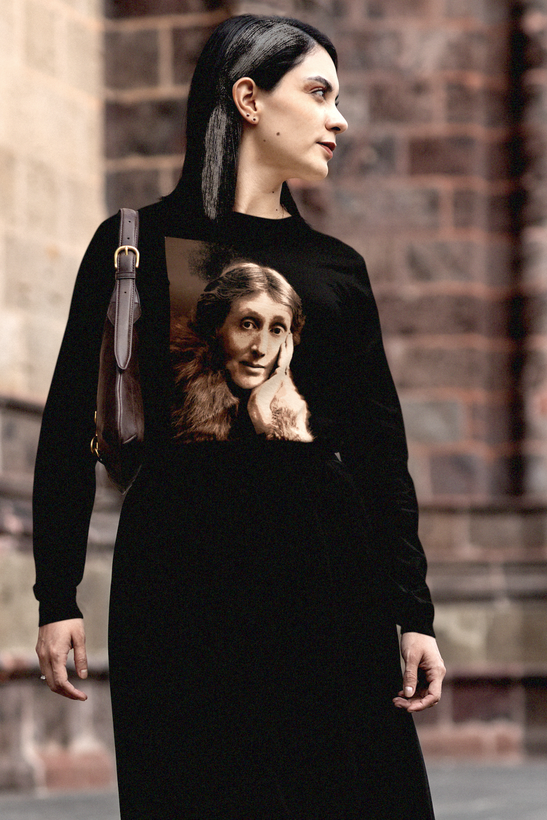 Gothesque grad student walking across campus wearing a long sleeve black jersey with a sepia portrait of Virginia Woolf. She made literature new—stream-of-consciousness, fractured time, inner lives spilling across the page. With novels like Mrs. Dalloway and To the Lighthouse, she redefined modernism not as escape but as immersion. 

Photo shows fit and style. Perfect gift for your book club fit or the English major in your life. Bella+Canvas 3501 #EUTC