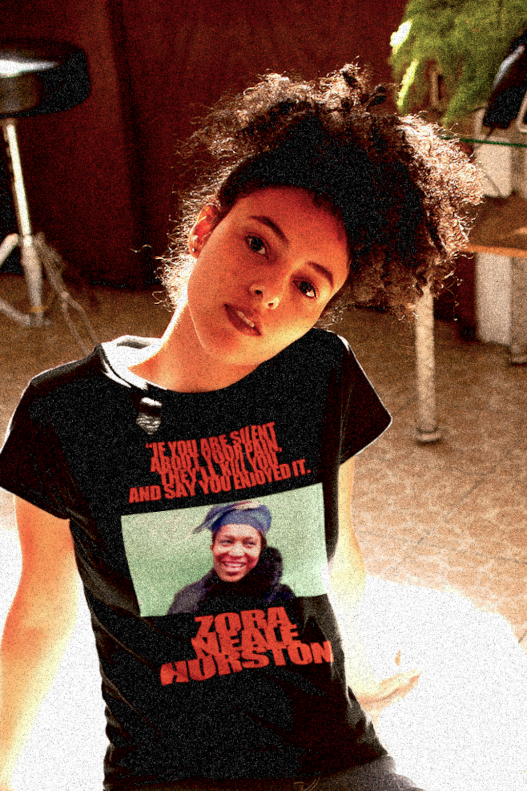 Inquisitive Black woman with long natural afro wearing a Black Relaxed Fit Women's T-Shirt: Zora Neale Hurston "If you are silent about your pain, they'll kill you and say you enjoyed it.”

Zora Neale Hurston didn’t just write novels; she bottled the rhythm and brilliance of Black life in the South and poured it straight onto the page. Cotton Bella+Canvas 6400 #EUTC